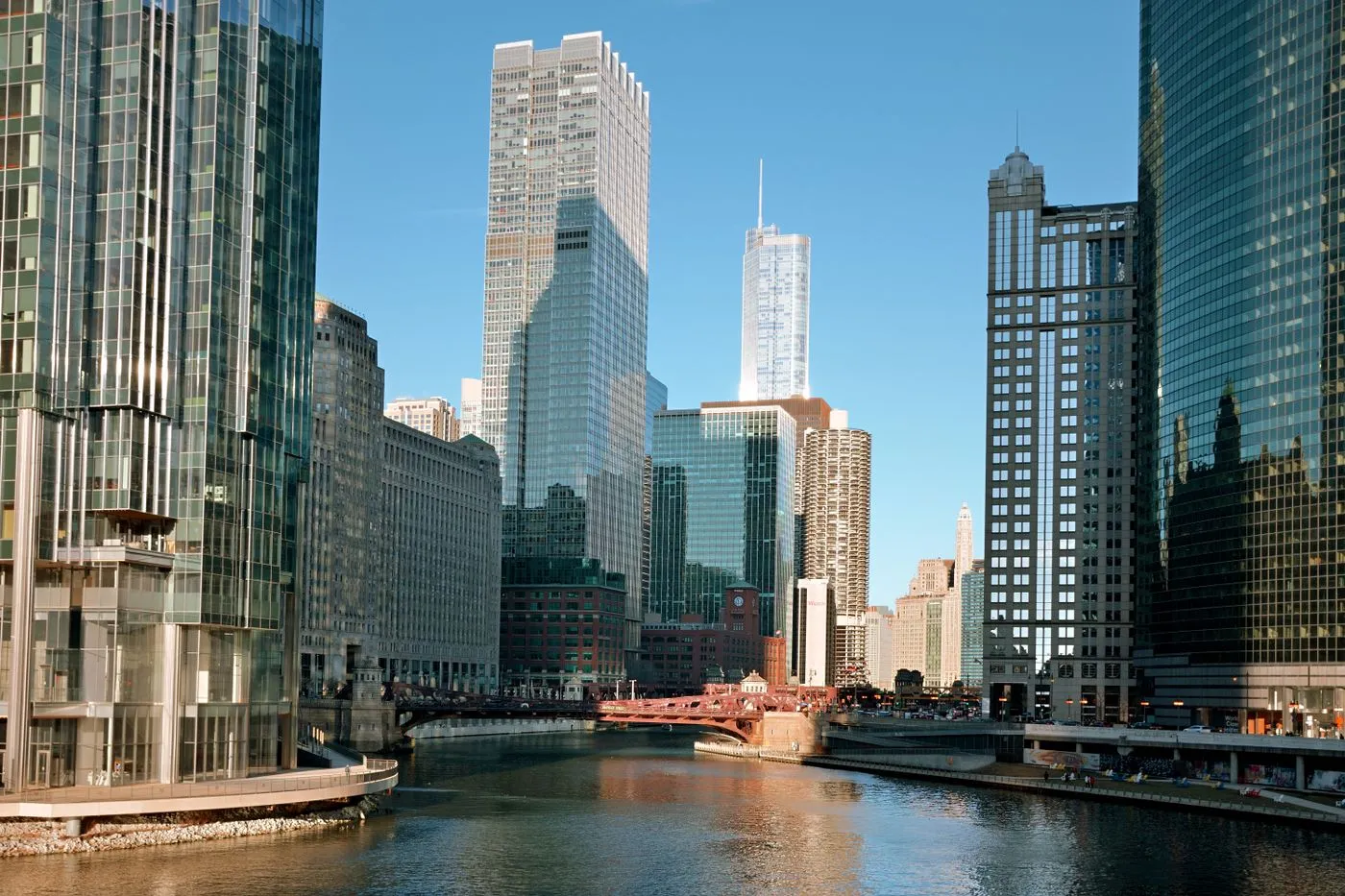 The Chicago River winding between downtown skyscrapers beneath a blue sky