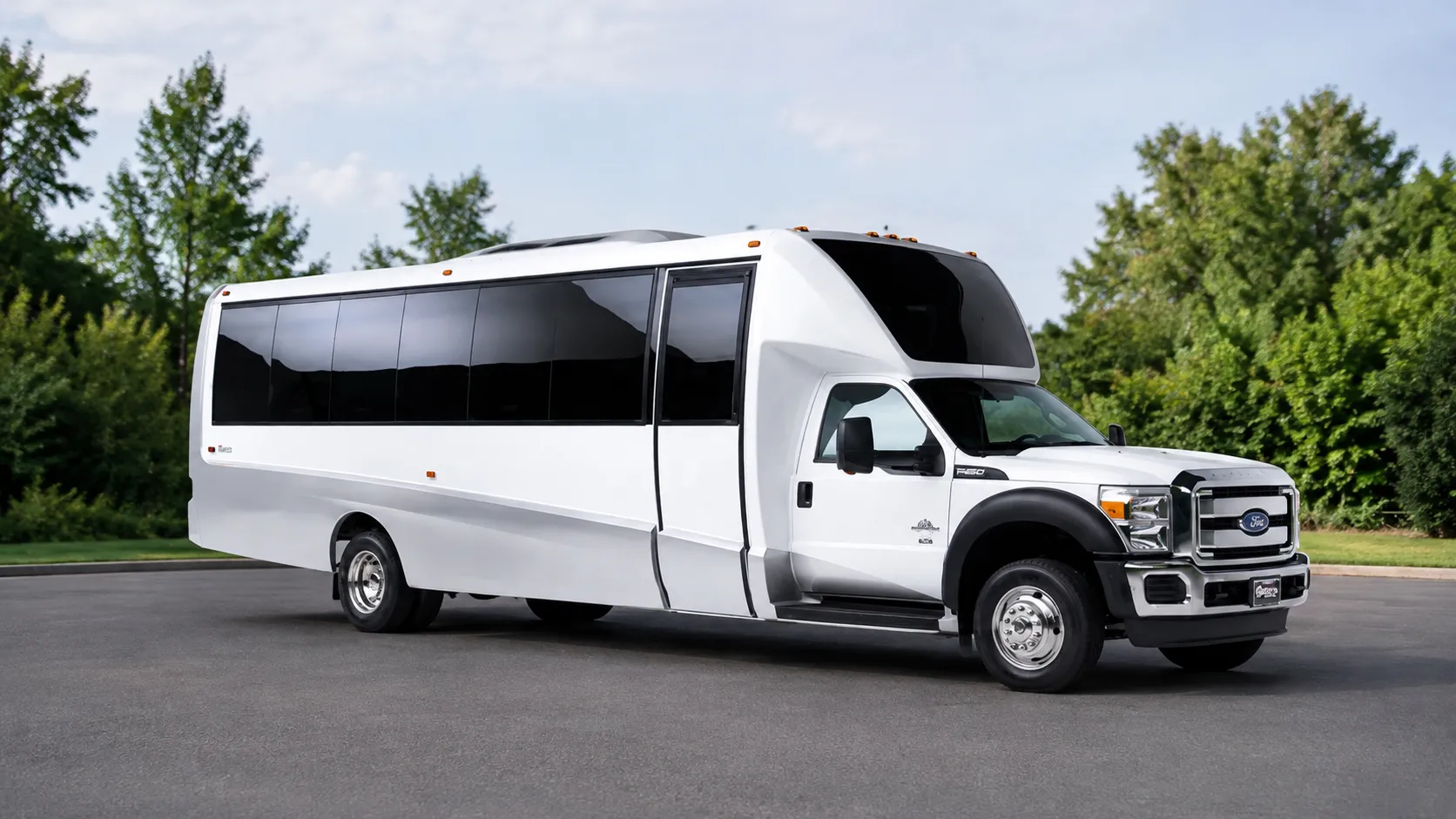 The Small Coach Bus, a white short coach, seen from the front and side