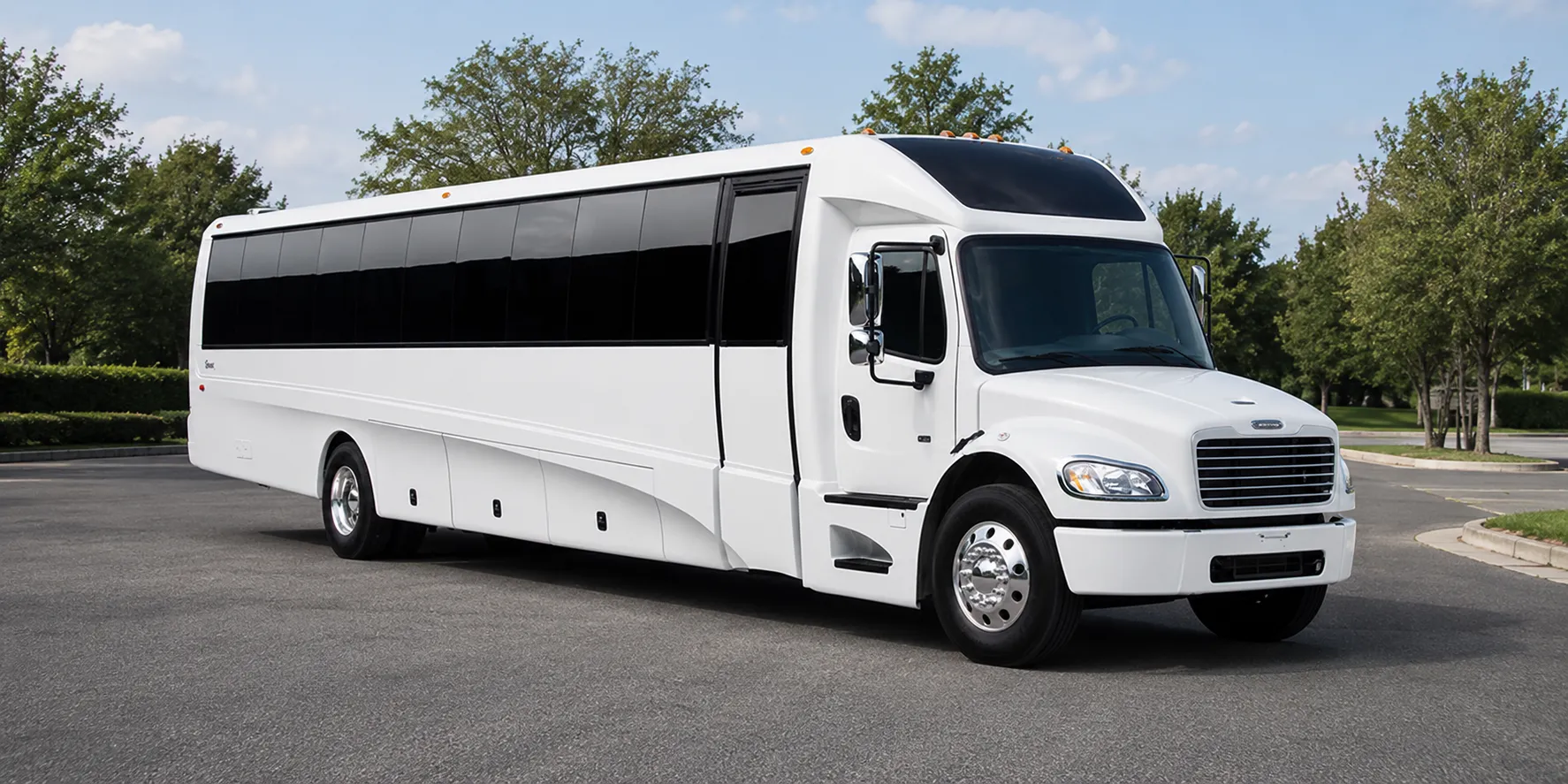 The Coach Bus, a white full-length coach, seen from the front and side