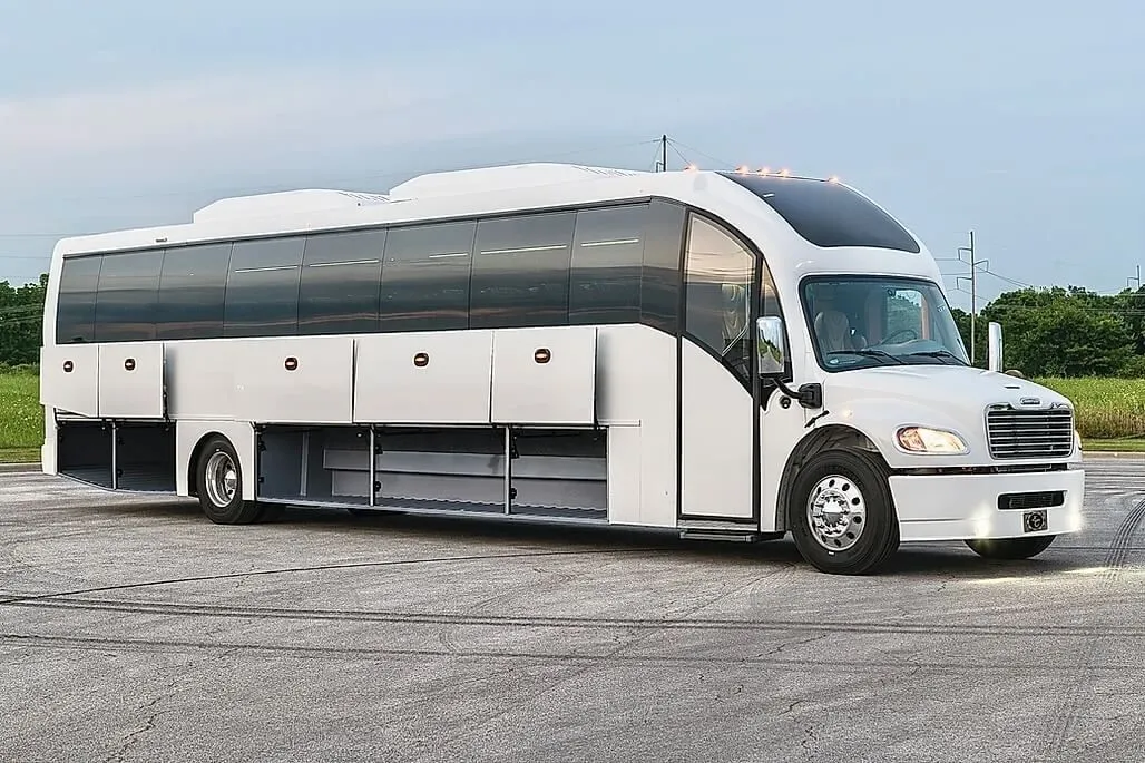 A white Chicago Super Coach bus parked with its luggage bays open