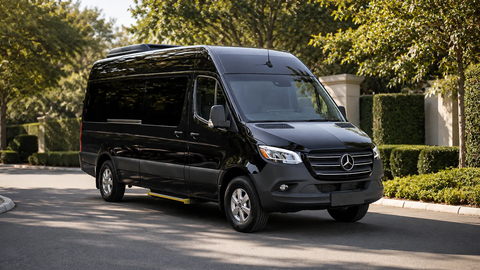 The Executive Sprinter Van, a black high-roof Mercedes-Benz Sprinter, seen from the front and side