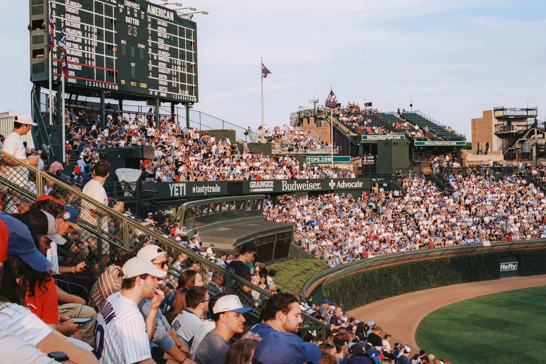 A packed crowd watching a baseball game at Wrigley Field in Chicago